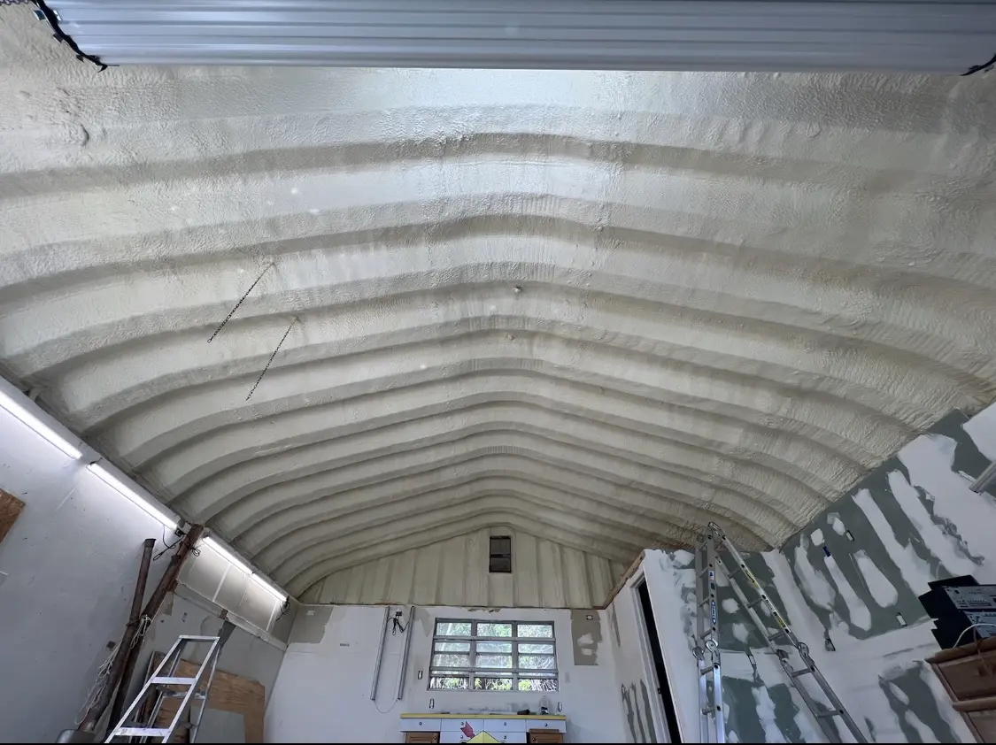 Spray polyurethane foam applied to the underside of a metal roof deck in Marion